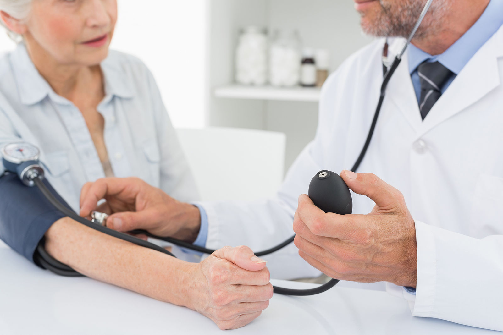 A consultant taking a patient's blood pressure